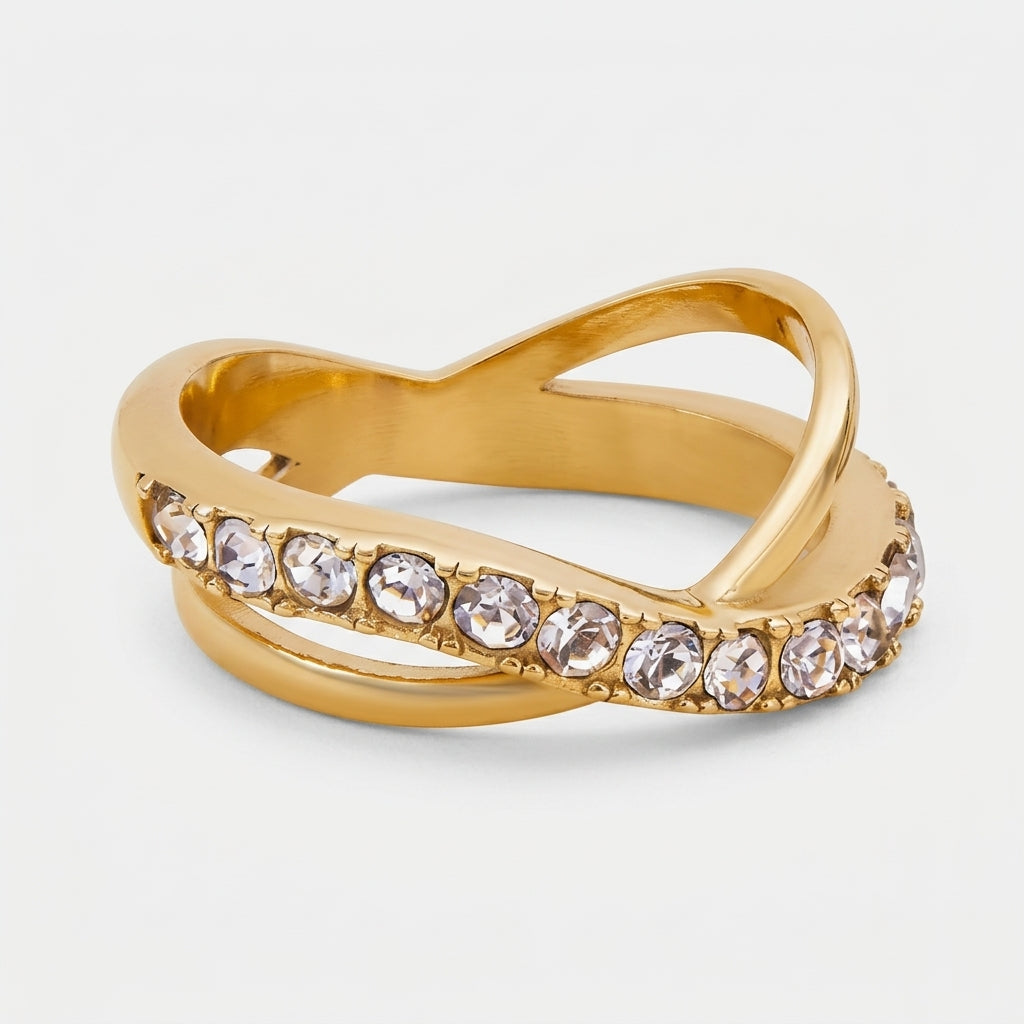 Goldfarbener LOCEVIA Ring mit überkreuzten geschwungenen Linien und einer Reihe runder facettierter Schmucksteine